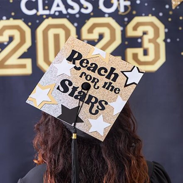back of student with decorated graduation cap